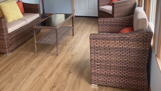 A cozy room with wicker furniture, a glass coffee table, and a wooden ceiling. - Cape May short walk to the Bay Dogs Welcome!  (Lower Township)