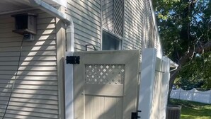 A white wooden gate with a latch, a small window, and a lattice design above it. - Cape May short walk to the Bay Dogs Welcome!  (Lower Township)