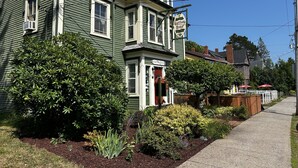 A two-story house with a porch and a sign that reads "Garrison House." - The Garrison House Inn (Annapolis Royal)