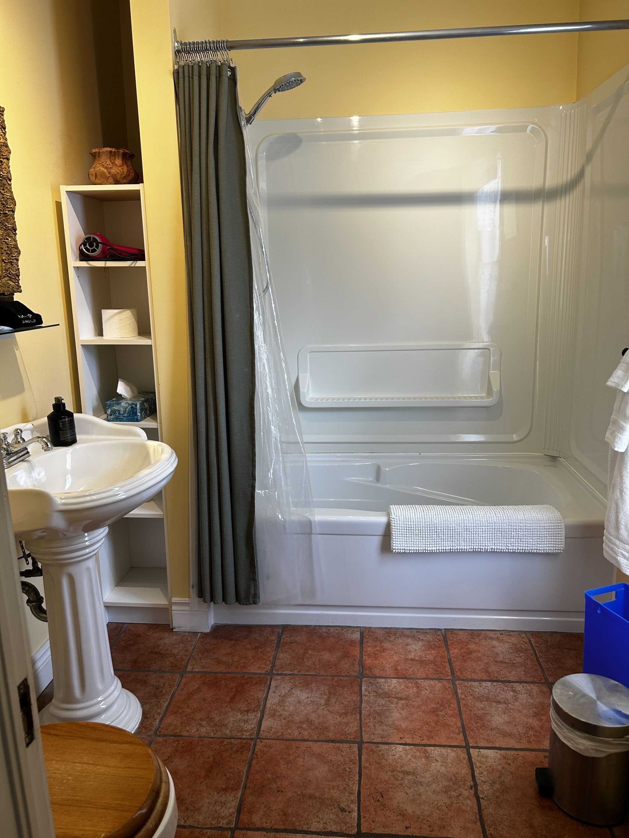 A bathroom with a bathtub, a sink, and a toilet.