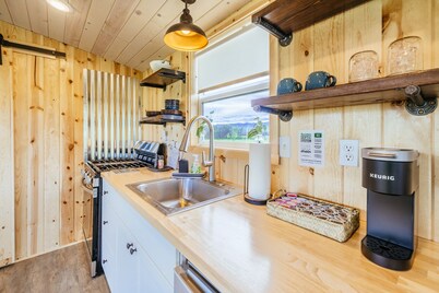 Off-grid tiny home in apple orchard with million-dollar mountain views!