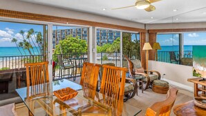 A spacious balcony with a glass table and chairs, overlooking a beach and ocean. - Oceanfront Hale Hui Kai 313 Large Lanai, AC, Incredible Views on Keawakapu Beach (Kihei)