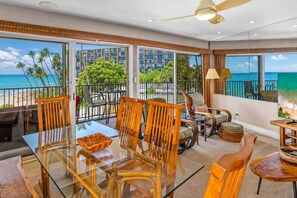 A spacious balcony with a glass table and chairs, overlooking a beach and ocean. - Oceanfront Hale Hui Kai 313 Large Lanai, AC, Incredible Views on Keawakapu Beach (Kihei)