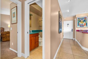 A hallway with a wooden cabinet, a sink, and a toilet. - Oceanfront Hale Hui Kai 313 Large Lanai, AC, Incredible Views on Keawakapu Beach (Kihei)