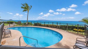 A swimming pool with a view of the ocean and a palm tree. - Oceanfront Hale Hui Kai 313 Large Lanai, AC, Incredible Views on Keawakapu Beach (Kihei)