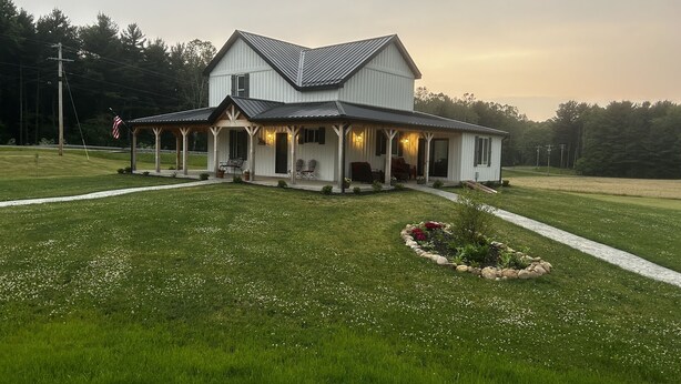 A large, single-story house with a covered porch and a well-maintained lawn.