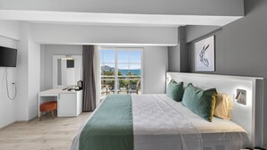 A modern hotel room with a bed, desk, and balcony with a view. - Mia Casa Hotel (Fethiye)