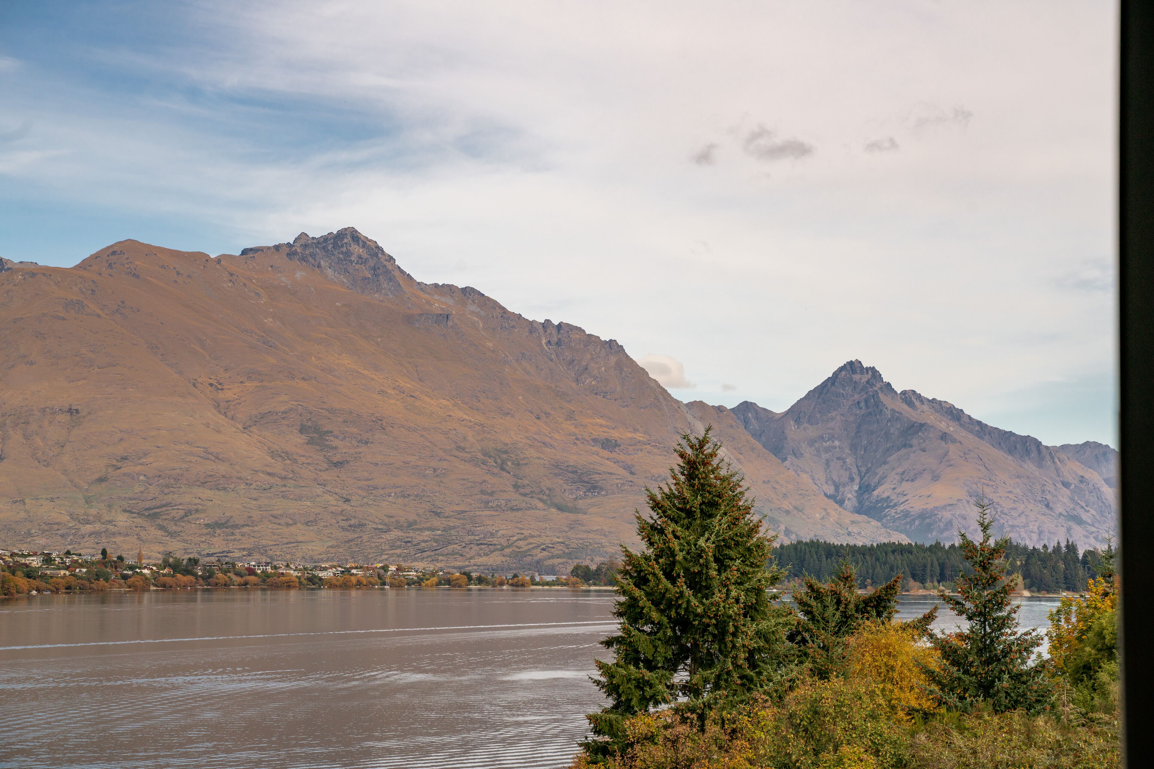 A mountainous landscape with a river and a town in the valley.