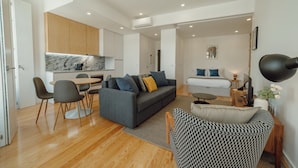 A modern apartment with a living room, dining area, kitchen, and a bedroom. - Courtyard Oporto Design Apartment D (Porto)
