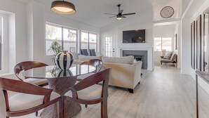 A spacious living room with a fireplace, a dining area with a round table and chairs, and large windows providing natural light. - Scottsdale Resort Getaway!! Newly Renovated!! (Scottsdale)