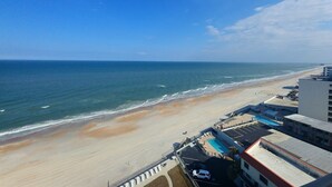 A beach view with a swimming pool and buildings in the foreground. - 12th Floor Oceanfront South End Unit overlooking Daytona (Daytona Beach)