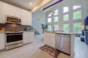 Enjoy cooking in this well-equipped kitchen with stainless steel appliances, ample counter space, and a large island with a dishwasher.
