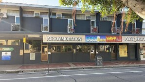 A building with multiple businesses including 'Accommodation', 'Cold Beer Hot Meals', and 'AYR Hotel'. - Ayr Hotel (Ayr)