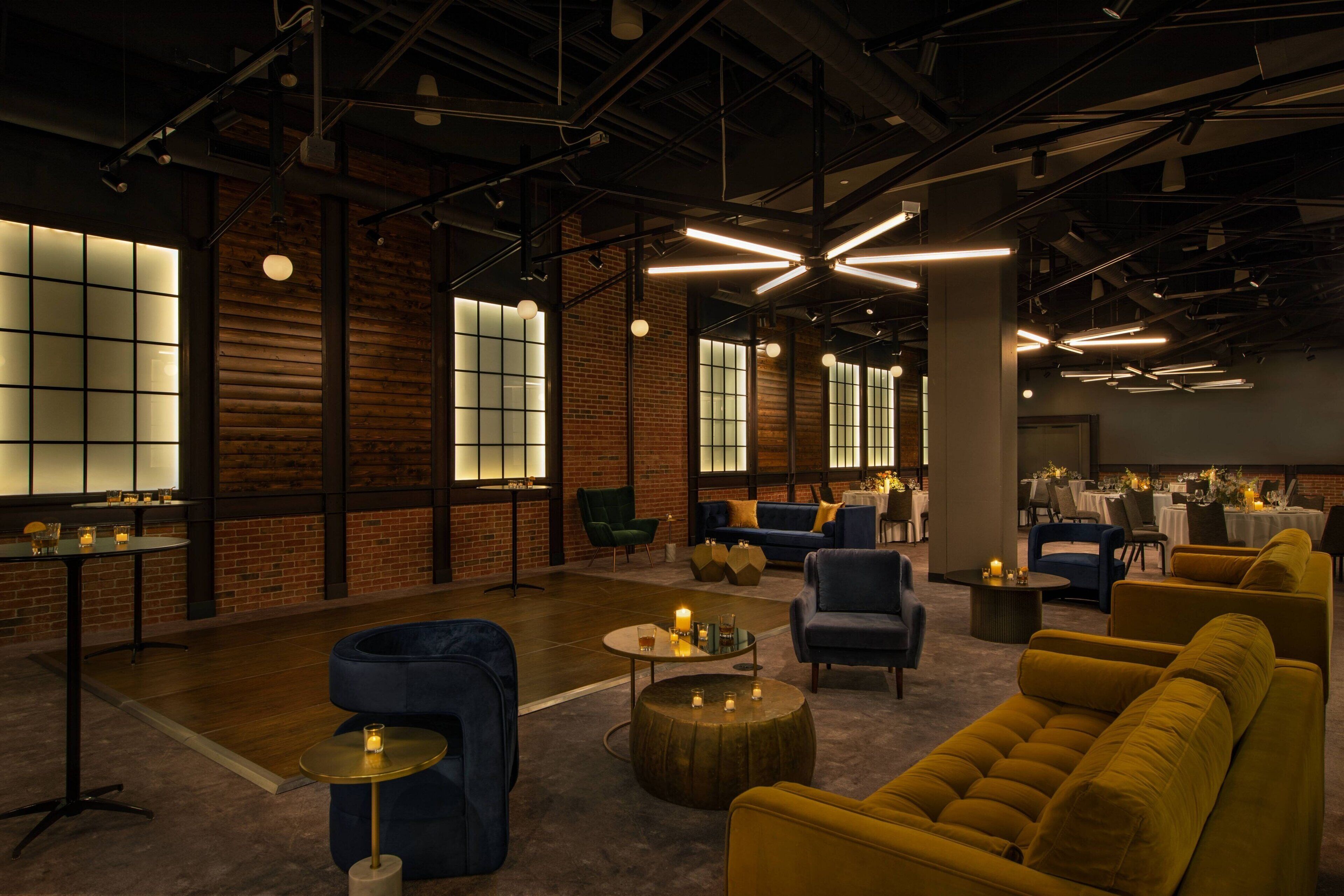 A modern lounge area with seating, tables, and ambient lighting.