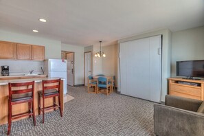 A compact living space with a kitchenette, a dining area, and a seating area. - Oceanfront One Bedroom Suite, Stunning Views & King Bed! (Lincoln City)