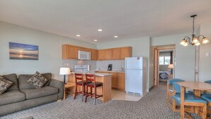 A compact living space with a kitchenette, a dining area, and a sofa. - Oceanfront One Bedroom Suite, Stunning Views & King Bed! (Lincoln City)