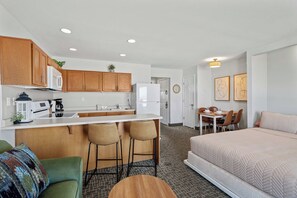 A compact apartment with a kitchenette, a dining area, and a bedroom. - Oceanfront Suite - Sleeps Six - Full Kitchen - Pool and Hot Tub! (Lincoln City)