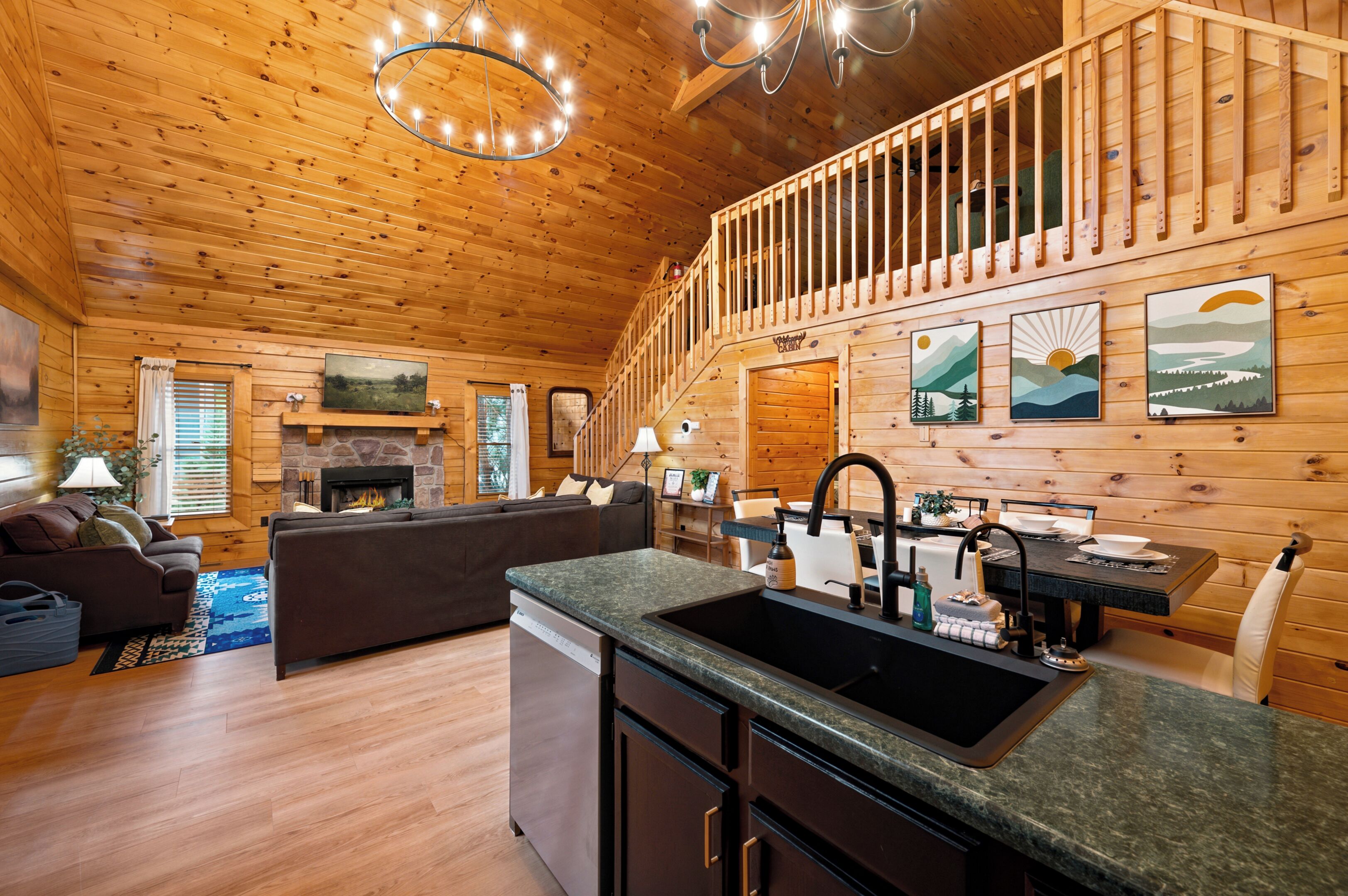A wooden cabin interior with a fireplace, a dining area, and a kitchen with granite countertops.