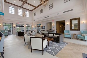 Relax in the spacious lobby with a sofa, armchairs, and dining area.