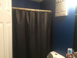 Bathtub, hair dryer, towels, soap