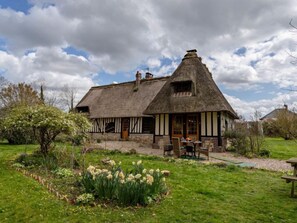 A traditional thatched-roof house with a garden in front. - La Chaumière by Interhome (Le Mesnil-St-Jean)