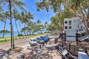 Enjoy stunning ocean views from Alassio Palm Cove, where palm trees line the walkway and a paved path leads to the beach.