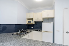 Fridge, microwave, stovetop, coffee/tea maker