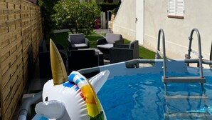 A swimming pool with a dolphin floatation device, a ladder, and outdoor furniture. - Superb upstairs villa with private garden and parking. (Saint-laurent-du-var)