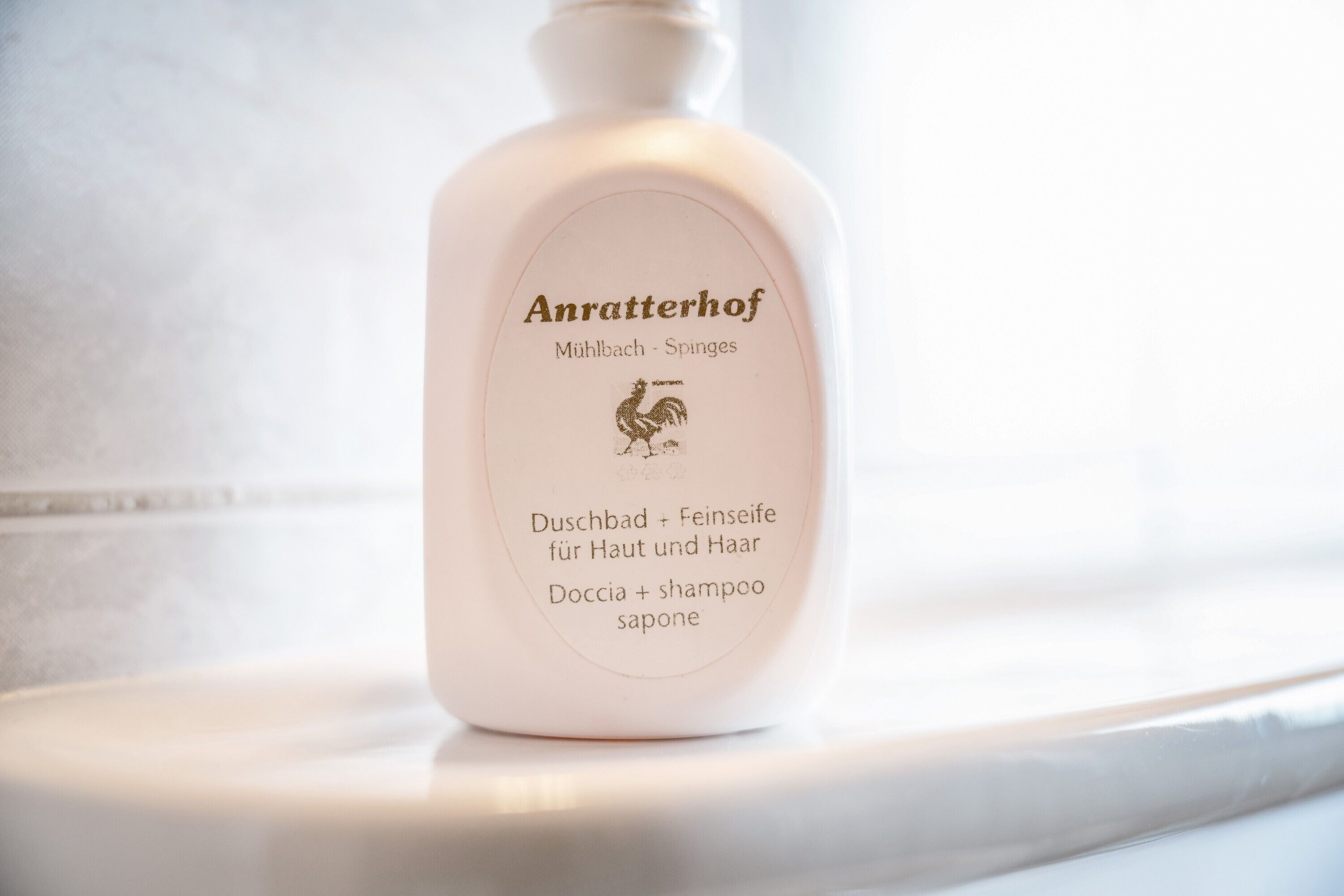 A bottle of Anratterhof shampoo on a white surface.