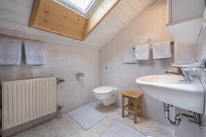 Banheira, secador de cabelo, toalhas de banho 