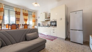 A modern kitchen with white cabinets, a stainless steel oven, and a refrigerator. - Holiday Home Villetta Luisa with Mountain View & Terraces (Villa San Pietro)