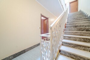 A staircase with marble steps and a white railing.