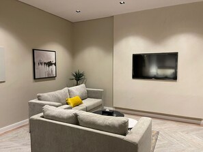 Executive Suite | Living area | 60-inch Smart TV with satellite channels, TV, fireplace - VOYAGE RESIDENCE (Riyadh)