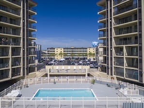 Enjoy the rooftop pool and lounge chairs from your balcony.