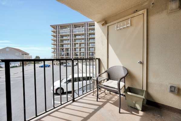 Enjoy the view from your balcony with a wicker chair and a comfortable cushion.