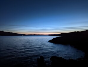 A calm body of water with a clear sky and distant landforms. - Lochaline Hotel (Oban)