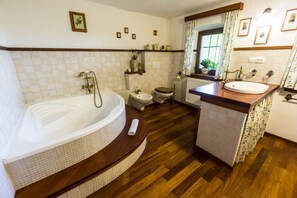 Bathtub, hair dryer, slippers, bidet