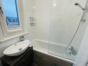 Combined shower/bathtub, hair dryer, towels, soap
