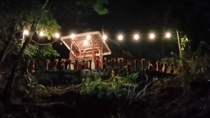 A wooden structure with a roof, surrounded by a low wall and potted plants. - Camping Ground Gunung Mijil Hils (Bantul)