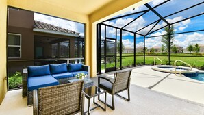 An outdoor patio with a sofa, chairs, and a hot tub. - Your Well-Deserved Resort Pool Home Getaway, Quality and Value, Mins to ºoº (Davenport)