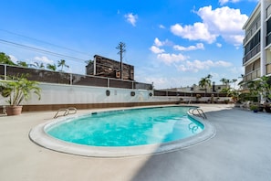 Relax by the clear pool surrounded by a deck and enjoy the serene views.