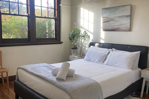 Front bedroom - lots of light, queen bed, lots of wardrobe space, phone charging