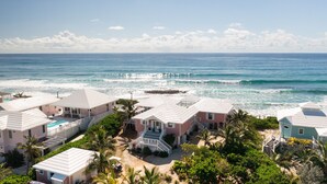 A coastal residential area with houses featuring white roofs and a swimming pool. - Endless Summer - Perfect Getaway near Tahiti Beach (Hope Town)