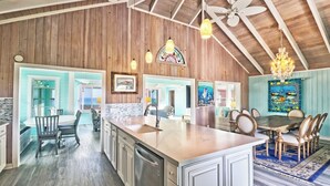 A spacious kitchen with wooden beams, a large island, and a dining area with a view. - Endless Summer - Perfect Getaway near Tahiti Beach (Hope Town)