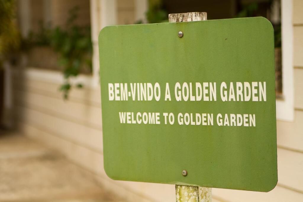 A green sign with white text welcoming visitors to Golden Garden.