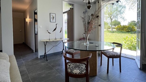 A modern dining area with a glass table, two chairs, and a decorative vase. - Between golf and beach (Pléneuf-Val-André)