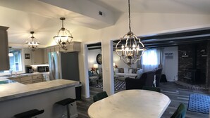 A modern kitchen with a central island, bar stools, and pendant lighting. - Upnorth with a dockslip (St. Helen)