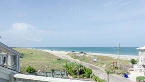 A beachfront property with a view of the ocean, a sandy beach, and a road leading to the beach. - Beautiful 1 BR Condo Overlooking Freeman Park (Carolina Beach)