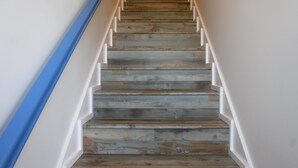 A wooden staircase with white railings and a blue handrail. - ~No Bad Days Townhome~ - 300ft to the sand! (Mexico Beach)