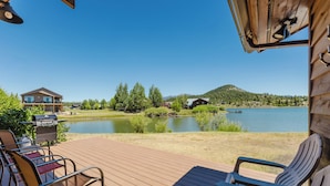 A wooden deck with outdoor seating, a grill, and a view of a lake and mountains. - On Lake Hatcher. Fish right from home. Hot Tub. (Pagosa Springs)